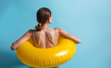 Portrait of a young woman relaxing with a rubber swimming pool ring on summer vacation