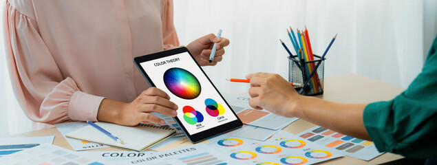 A cropped picture of professional designer selects the color by using color theory and comparing...