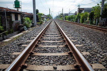 Railway tracks around settlements in rural areas in Indonesia - obrazy, fototapety, plakaty