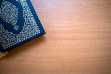 The Qur'an, the holy book of Muslims on a wooden table