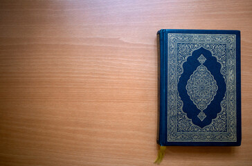 The Qur'an, the holy book of Muslims on a wooden table