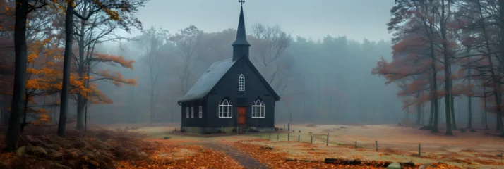 Fototapeten Old abandoned black wooden chapel on foggy, Beautiful church in the mountains at sunset Beautiful autumn landscape © david