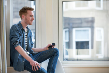 Portrait of a student relaxing at home.