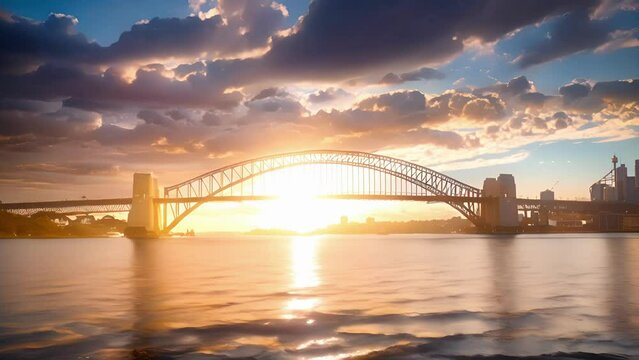 The last rays of sunlight paint the sky in a golden glow behind a renowned bridge in a picturesque city.