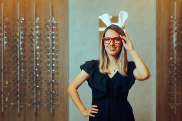 Woman Wearing Red Eyeglasses and Easter Bunny Ears. Cheerful customer celebrating holiday discount...