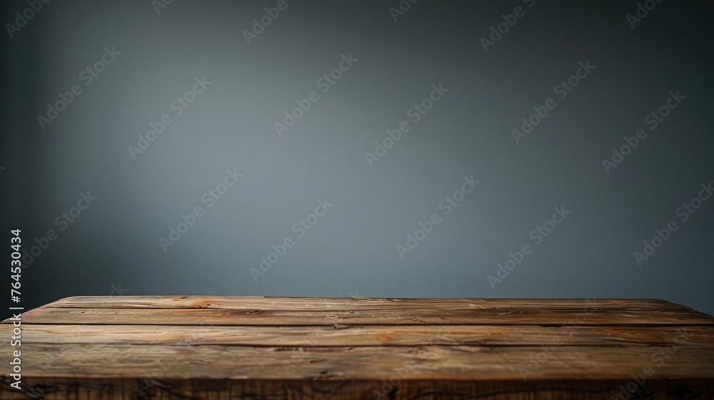 Poster a simple wooden table with a gray wall in the background. suitable for various interior design conce