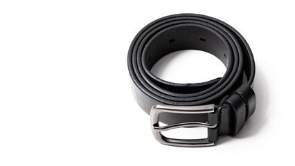 Obraz premium Twisted black leather belt with matted metal buckle isolated on white background. Fastened fashionable unisex, man or woman accessory for trousers, jeans, dress. Male luxury strap. Haberdashery goods