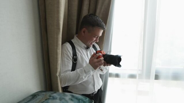 Male photographer taking a photo in a room. 