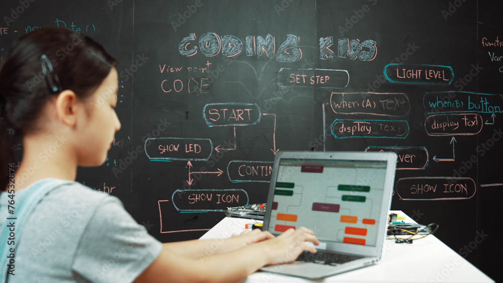 Poster young happy asian girl coding and programing prompt at blackboard. highschool student using laptop w