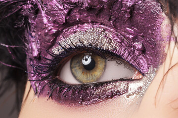 Beauty, cosmetics and makeup. Magic eyes look with bright creative make up. Macro shot of beautiful...