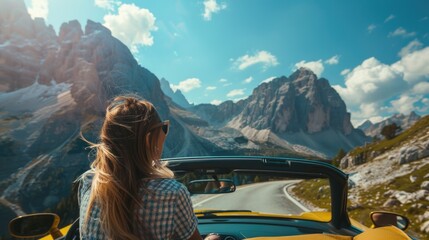 Woman driving yellow convertible on scenic mountain road, perfect for travel blogs or car advertisements - obrazy, fototapety, plakaty