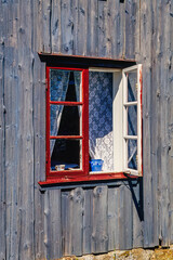 Open window of an old cottage in summer