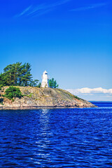 Rocky islet with a lighthouse in an archipelago