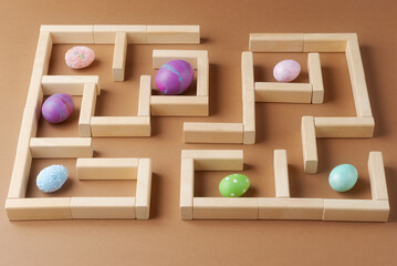 Vibrant Easter Eggs in Wooden Maze. Easer tradition concept related to egg hunt or search