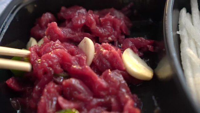 Yukke raw beef korean delicacy meat eating in South Korean market