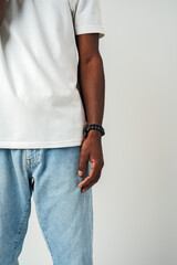 African Man in Blue Jeans standing on gray background