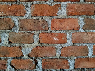 The wall is built with clay bricks and cement