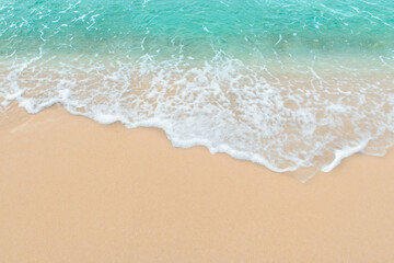 Fototapeta na wymiar Tranquil Summer Beach Scene, Serene Wave on Deserted Sandy Shore with Ample Copy Space.