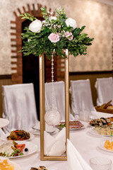 Decorative still life with a bouquet of white roses on the wedding table
