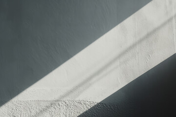 Angular shadow cast across a textured white wall, contrasting with the natural light