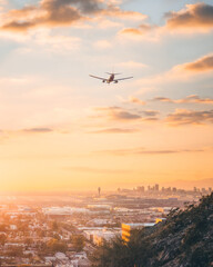 airplane in the sky at sunset