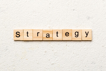 STRATEGY word written on wood block. STRATEGY text on cement table for your desing, concept