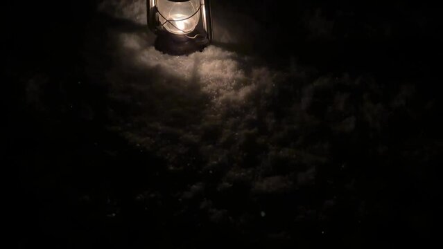 Old antique oil lantern retro kerosene lamp oil in snow in backyard the vintage copper oil lamp in winter season light fire flame burning fuel to light in darkness in rural life Iran local people town