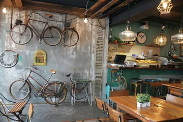 Papier Peint photo Vélo A bicycle-themed cafe with vintage bike decor, bicycle racks for parking, and a menu inspired by the cycling culture, Generative AI