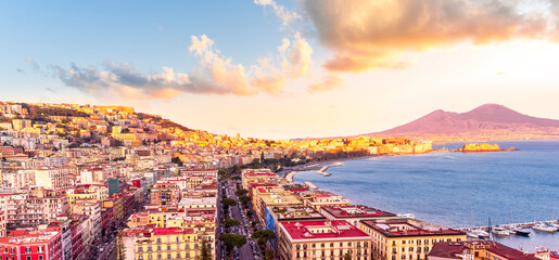 beautiful panorama of Naples city with amazing coast, sea port, streets and buildings and volcano Vesuvius with anazing sky on background