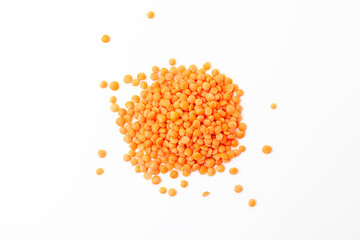 Red lentils pile on white background. Dry orange lentil grains. Top view