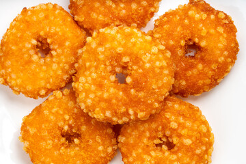 Fried fish donuts on White plate.,