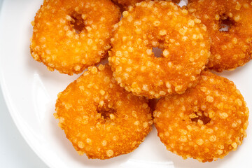Fried fish donuts on White plate.,