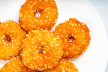 Fried fish donuts on White plate.,