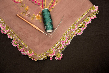 Hand-knitted scarf and headscarf samples, handmade embroidered and red head scarf, crochet and knitting thread close-up.