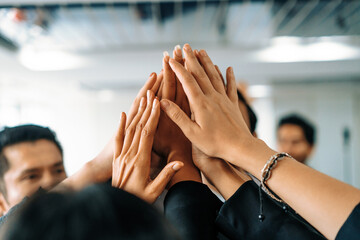 Many happy business people raise hands together with joy and success. Company employee celebrate...