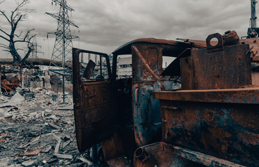 Fototapeta premium burnt cars and destroyed buildings of the workshop of the Azovstal plant in Mariupol