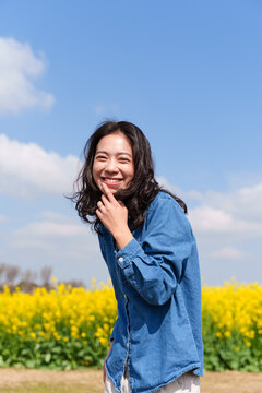 happy young asian woman smile at camera in the sunny spring day