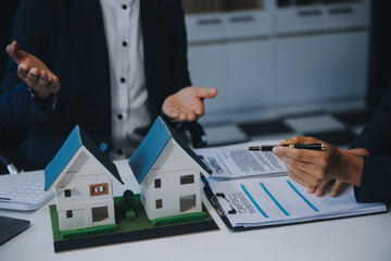 Real estate agent talked about the terms of the home purchase agreement and asked the customer to sign the documents to make the contract legally, Home sales and home insurance concept.