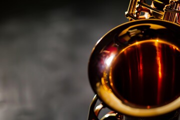 saxophone bell closeup, the rest of the horn falling into shadow