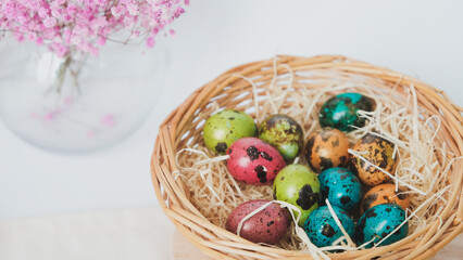 Easter quail eggs in a basket. Easter composition. Holiday concept.
