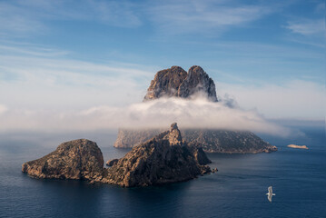 Es Vedra and Es Vedranell islets covered with low sea clouds, Cap des Jueu, Sant Joan de Sa Talaia,...