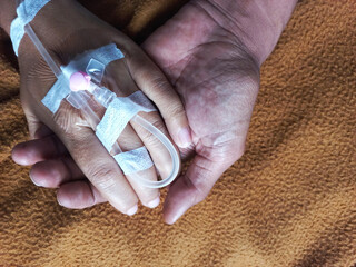 Reaching, grabbing and Holding an infusion hand in the hospital for giving support