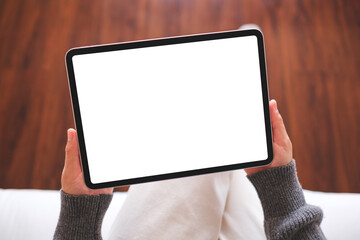 Top view mockup image of a woman holding digital tablet with blank desktop screen at home