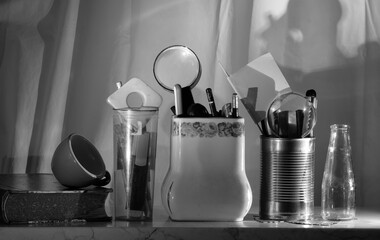 office supplies a book and a coffee cup in a row black and white shot. Home office, work,concept - 764605207