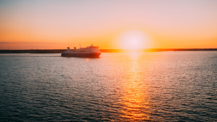 Stockholm, Sweden. Tourist Ship Or Ferry Boat Boat Liner Floating Near Islands In Summer Evening. Beautiful Seascape In Sunset Sunrise Time. Sun Sunshine Above Islands Archipelago. - 764606671