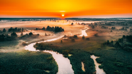 Aerial Elevated View Green Meadow And River Landscape In Misty Foggy Morning. Top View Of Beautiful European Nature From High Attitude In Summer Season. Drone View. Bird's Eye View. - 764609635