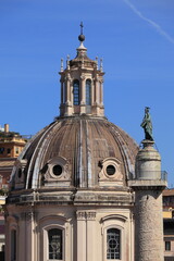 Fototapeta na wymiar Santissimo Nome di Maria al Foro Traiano Church Dome with Trajan's Column Statue in Rome, Italy
