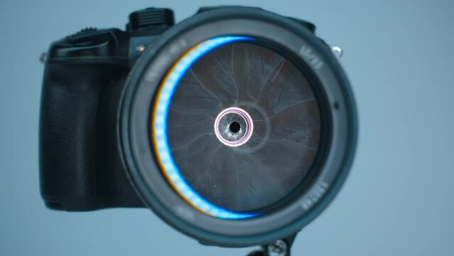 A professional camera on a tripod with an expensive lens with an aperture of 1.5 and a focal length of 85 mm, which reflects the ring LED light. Closeup. Macro. Shot in motion