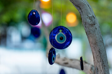 nazar, amulets, talismans against the evil eye on a tree in the garden.
