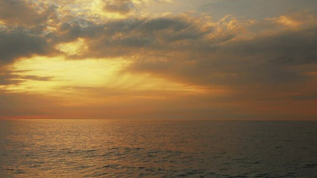 Wavy sea and endless horizon at sunset.